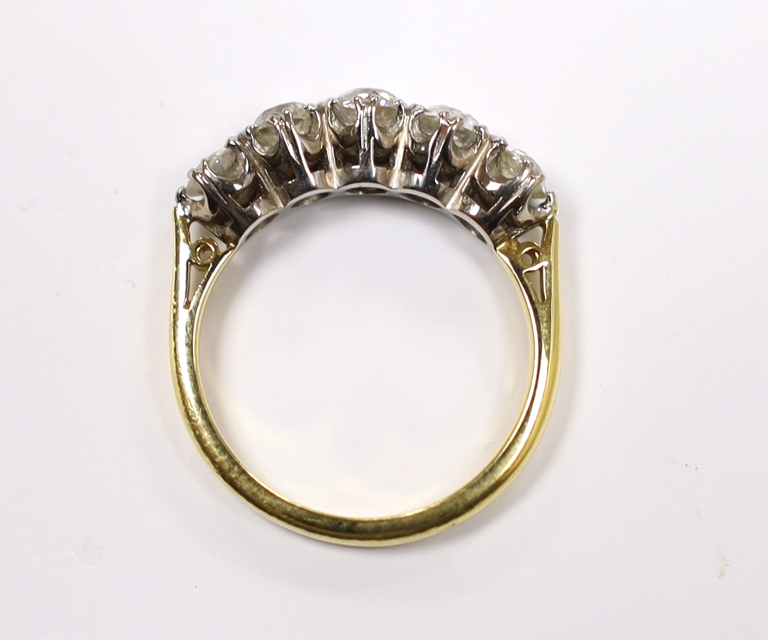 A modern 18ct gold and graduated five stone diamond set half hoop ring, size M, gross weight 4.5 grams.